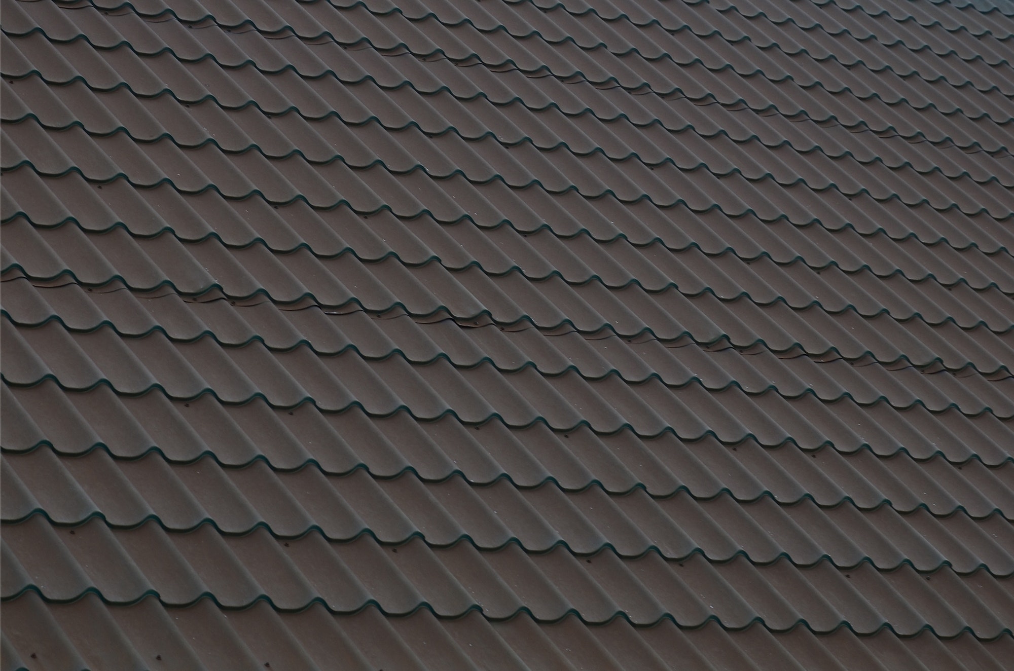 Brown metal roof tiles. Metal Roof Shingles - Roofing Construction