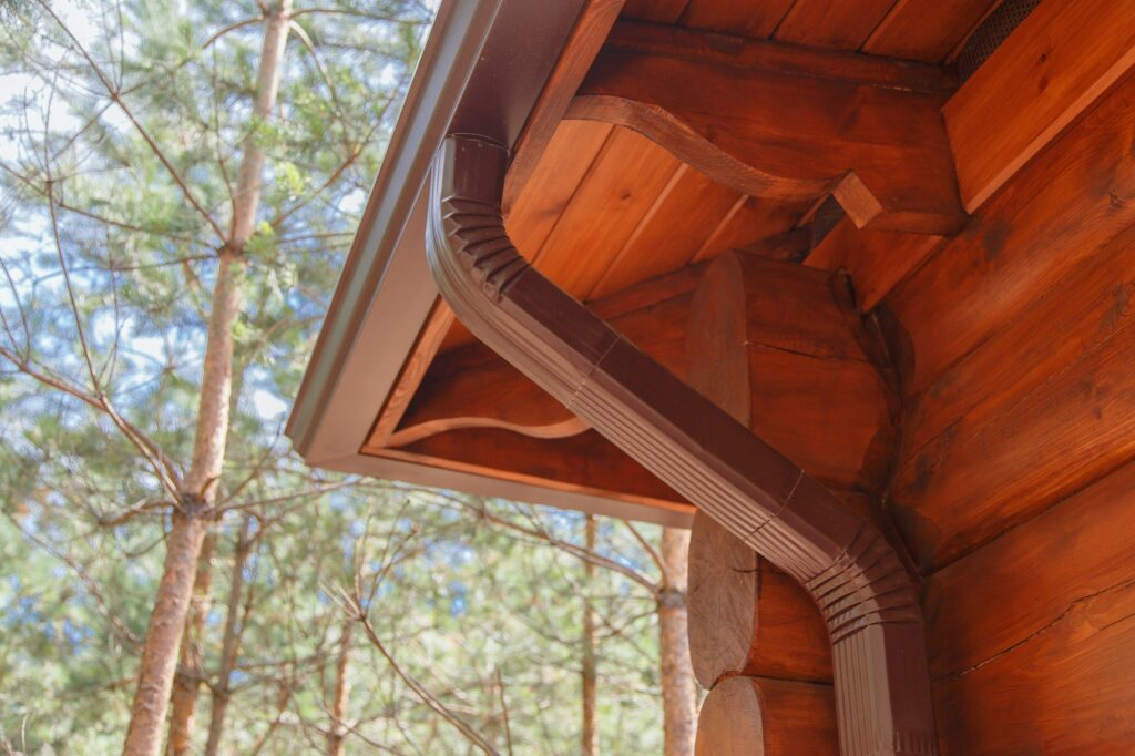 Roof gutter system on log house in forest