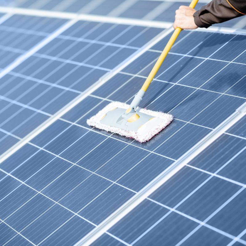 Workman cleaning solar panels Workman cleaning solar panels